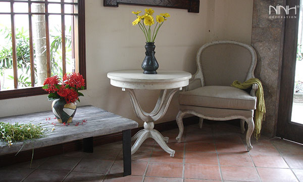 White arm chair and round table