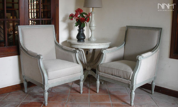 Two light grey arm chair and round coffee table